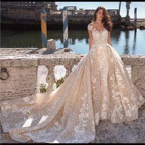 Brand new wedding dress, size 14. Demetrio’s brand.